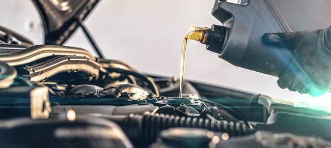 oil being poured into an engine